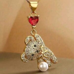 Gold-tone teddy bear pendant necklace featuring a ruby-red heart