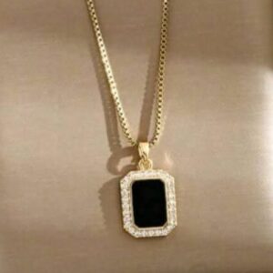 Gold-tone necklace features a rectangular black stone pendant