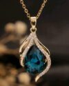 Gold plated teardrop zirconia pendant necklace featuring a blue crystal flame design