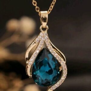 Gold plated teardrop zirconia pendant necklace featuring a blue crystal flame design