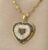 Gold-plated heart pendant necklace featuring a design of black and white cubic zirconia